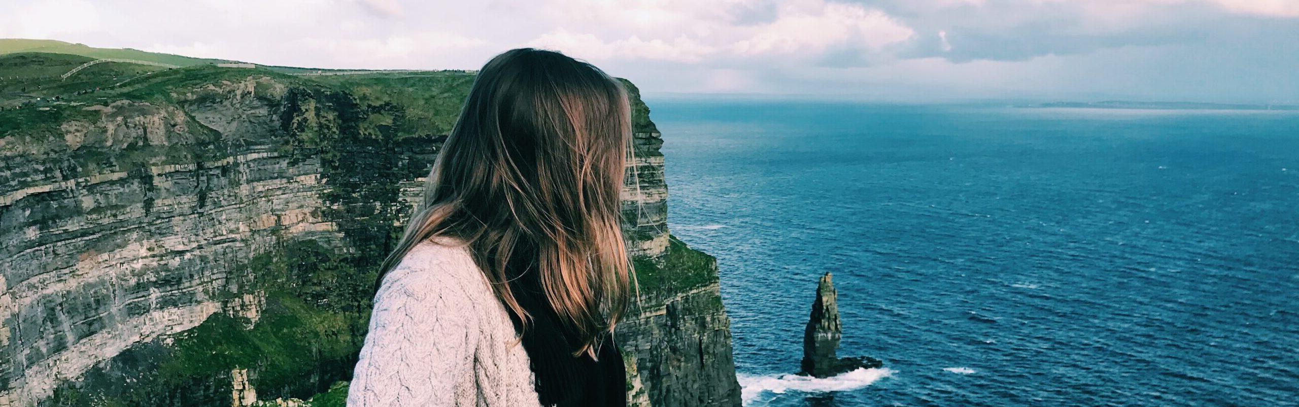 Student standing at the Cliffs of Moher